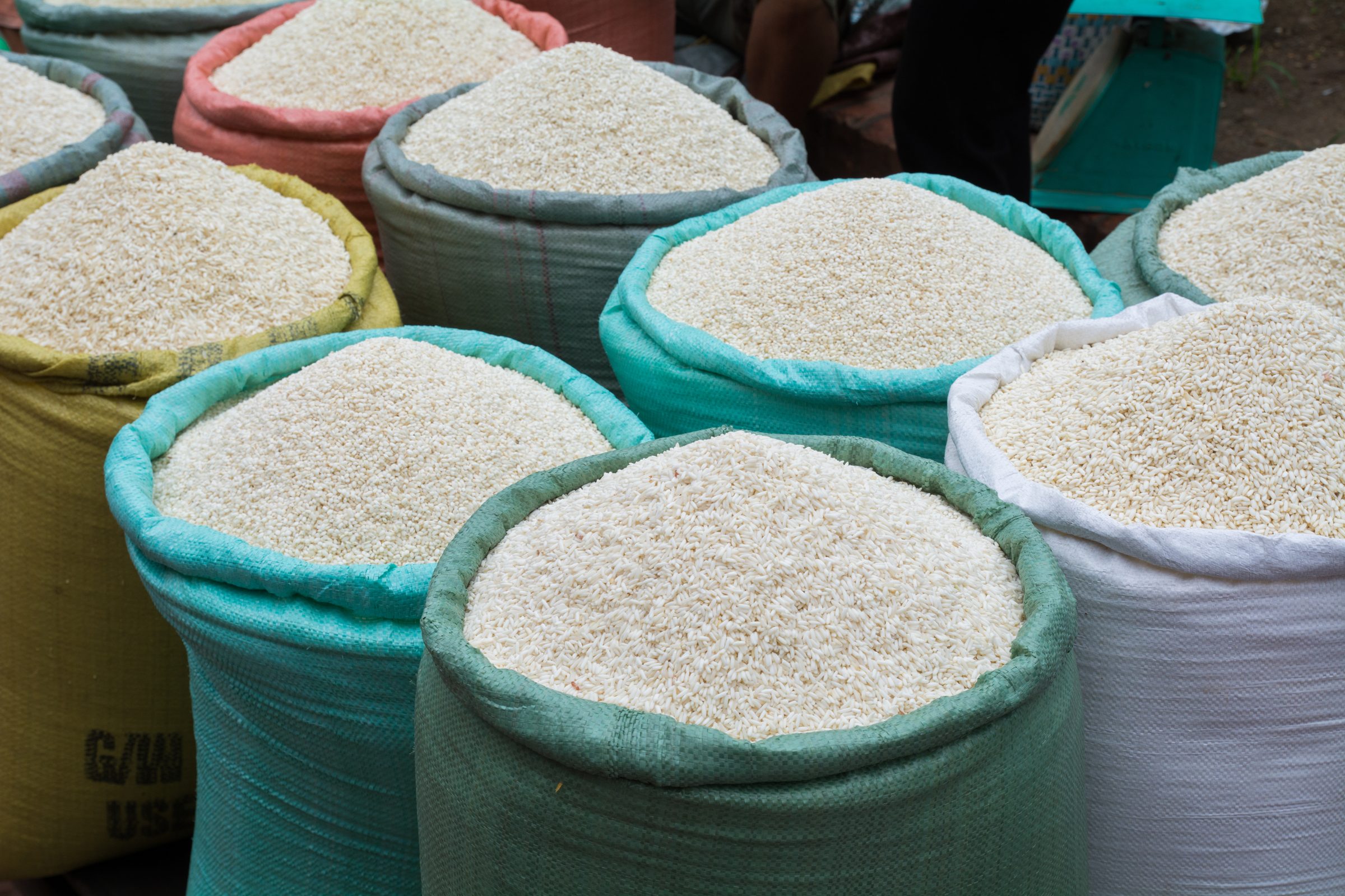 Open sacks of white rice at a market